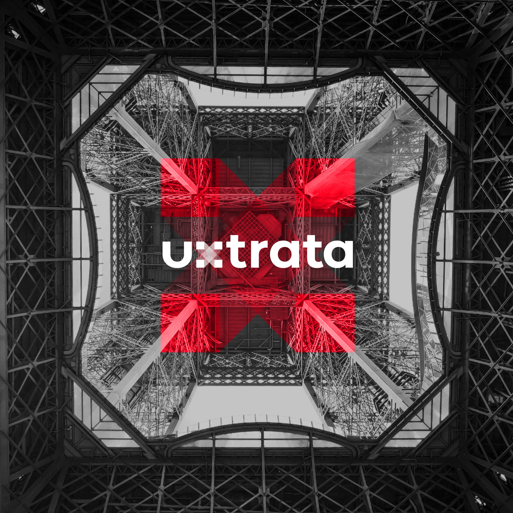 Uxtrata Red Logo with building in the background worms eye view
